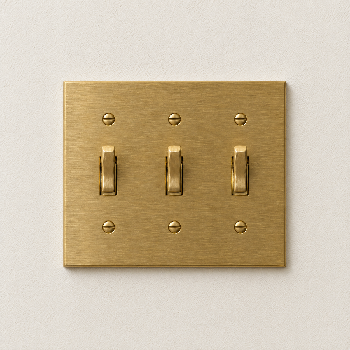 3-Gang Toggle Switch in Unlacquered Brass, front view