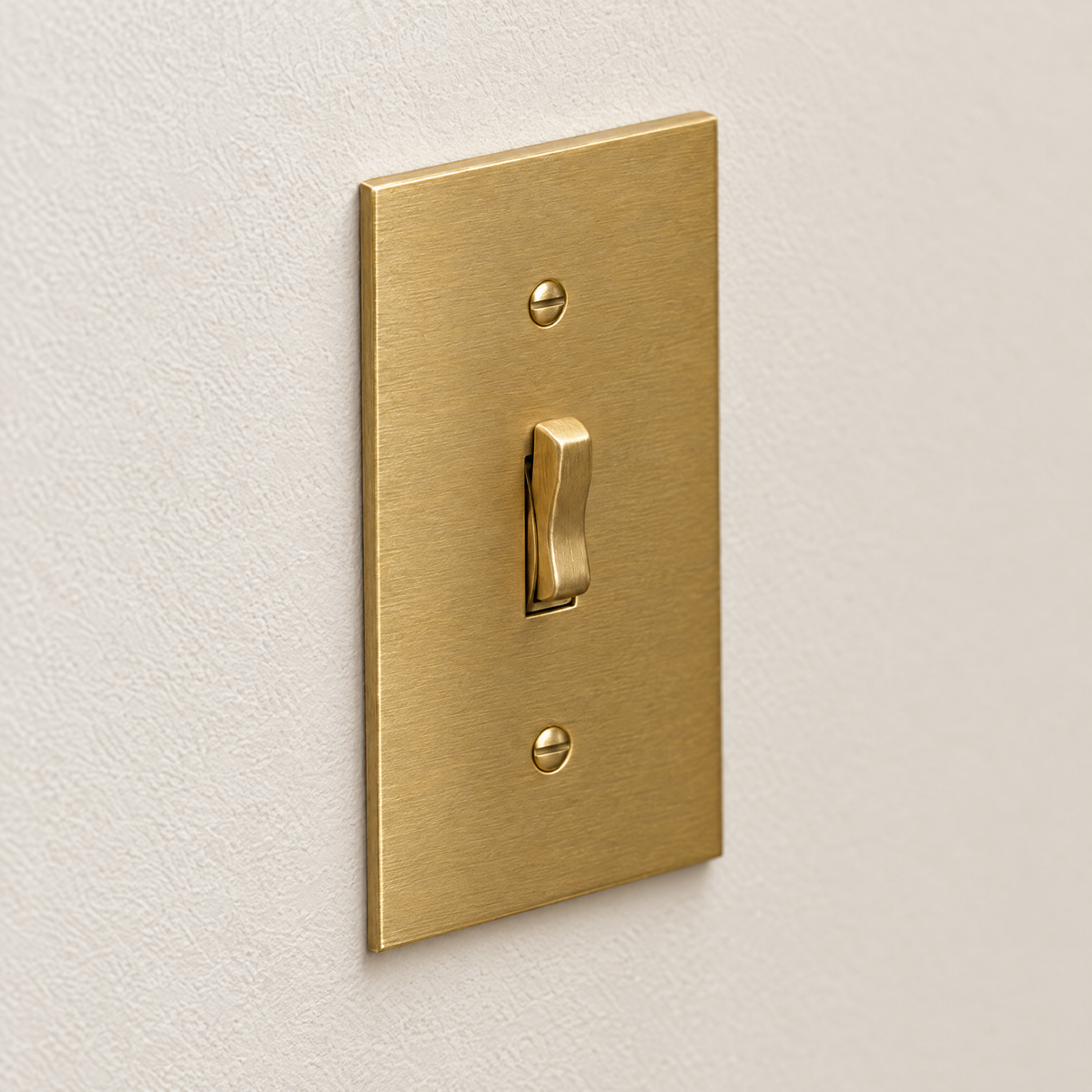 1-Gang Toggle Switch in Unlacquered Brass, angled view showing solid brass plate edge